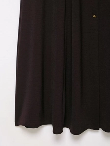 Detailed macro view of deep brown fabric with a gold dome button accent