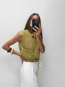 Olive green chunky knit sleeveless vest with hollow texture and decorative large buttons