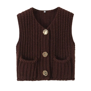 Close-up of deep brown chunky knit vest featuring V-neck and textured gold buttons