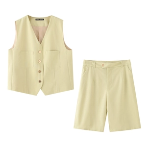 Detail of a light green cotton linen vest set showing four buttons and front pockets