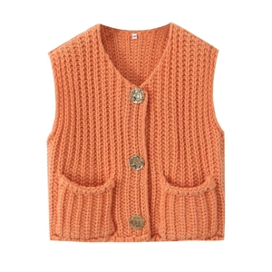 Detail of coral knit vest with golden textured buttons and large front pockets