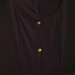 Detailed view of deep purple midi dress featuring gold buttons and invisible zipper closure