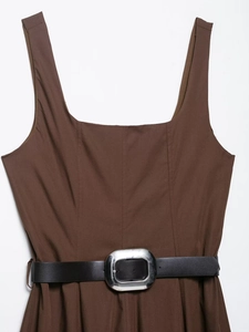 Close-up of square neck sleeveless brown midi dress with black belt and silver buckle