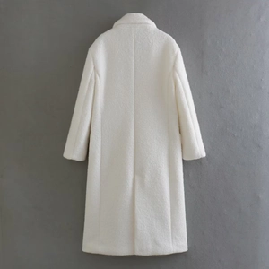 Detail of white long faux fur coat showing soft plush texture and vertical back stitching
