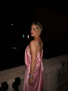 Detail view of the pink satin backless dress showing smooth fabric and elegant drape