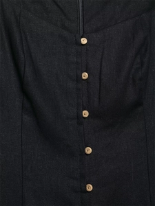 Detailed macro shot of black linen dress featuring zipper closure and brown buttons