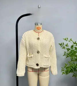 Detailed view of chunky knit vest featuring vintage metal buttons and pocket texture