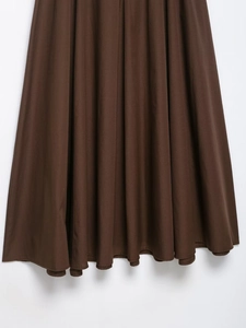 Close-up of the dark brown midi dress hem showing premium fabric texture and clean stitching
