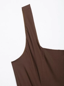 Detail of square neckline and wide straps on a dark brown midi dress with precise stitching