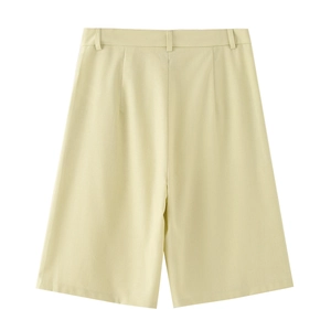 Detail view of high-waisted pale yellow cotton linen shorts with structured A-line silhouette
