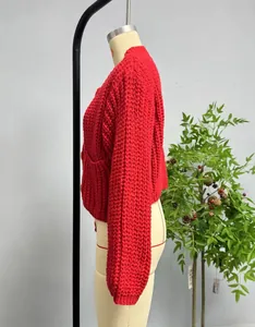 Side view of red chunky knit cardigan with textured fish-scale pattern and pocket