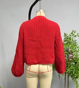 Detail of red chunky knit cardigan back showing textured honeycomb weaving pattern