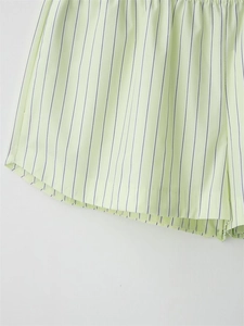 Detailed texture of light green striped poplin shorts with elastic waistband