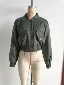 Detail of army green satin bomber jacket with chest flap pockets and ribbed hem cuffs