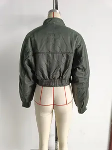 Detail view of the back of a dark green quilted bomber jacket with ribbed hem and cuffs