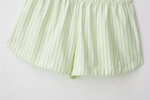 Detail of light green striped poplin shorts showing high-quality fabric and elastic waist