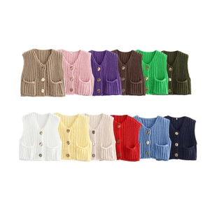 Detail showing twelve colors of V-neck chunky knit vests with buttons and pockets