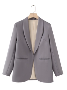 Detailed view of dark grey blazer with shawl lapel and decorative pockets on hanger