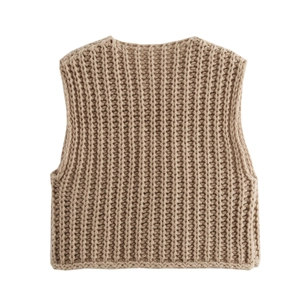 Macro detail of camel chunky knit vest showing rich ribbed texture and thick yarn