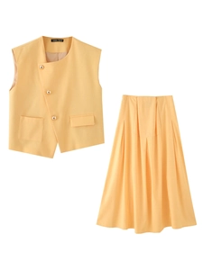 Detail of yellow cotton vest with gold buttons and pleated maxi skirt set