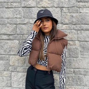 Women's cropped dark brown puffer vest with stand collar and adjustable drawstring hem