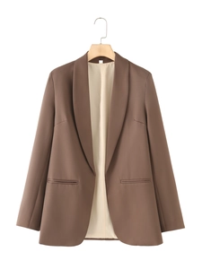 Detail view of shawl lapel and flat side pockets on brown casual blazer for women