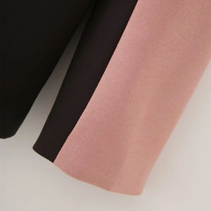 Detail of dusty pink and black contrast stitching and fine twill fabric texture