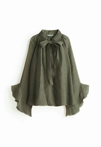 Detail of dark green chiffon blouse featuring elegant bow tie neck and ruffle flare sleeves