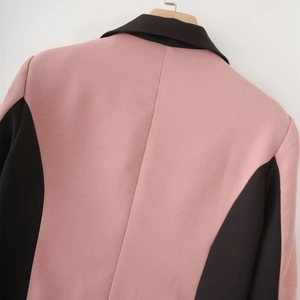 Detail of pink and black color-block blazer back view with premium woven texture