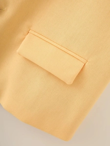 Detailed close-up of the flap pocket and fabric texture on this apricot cotton vest
