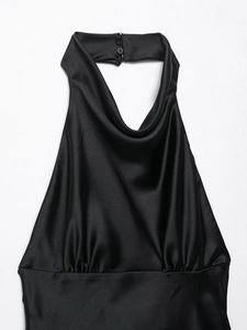 Detail of black silk halter top with elegant draped neck and triple button closure