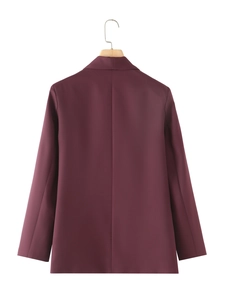 Detail view of the back seams and tailored fit on a deep burgundy shawl collar blazer