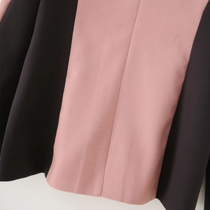 Detail of pink and black vertical color-block skirt with neat stitching and woven texture
