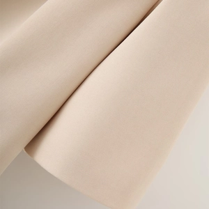 Macro detail of premium beige twill fabric with dense texture for elegant blazers
