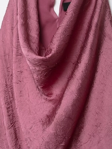 Detail of rose pink midi dress featuring elegant cowl neck and crinkled texture fabric