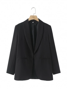 Detail of a black shawl lapel blazer with symmetric pockets on a wooden hanger