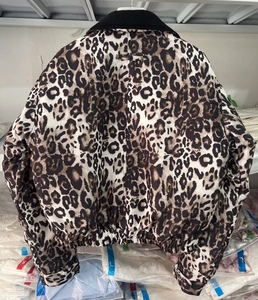 Back view of a leopard print bomber jacket with black ribbed collar and elastic hemline