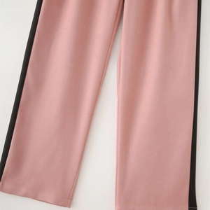 Detail of pink straight-cut trousers featuring sporty black contrast side stripes