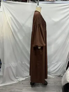 Detailed view of the fine pleating on the chest and voluminous lantern sleeves of the dress
