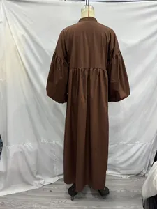 Rear view of dark brown maxi dress featuring puff sleeves and pleated waist details