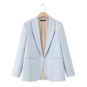 Detail of light blue blazer with shawl collar, featuring inside lining and brand label