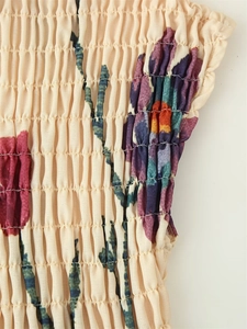Detailed macro shot of vintage floral printed smocking and shirring on fabric