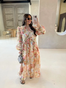 Detail of floral V-neck maxi dress with long sleeves and colorful flower pattern
