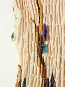 Detailed macro view of smocking stitching on printed linen blend fabric for women dress