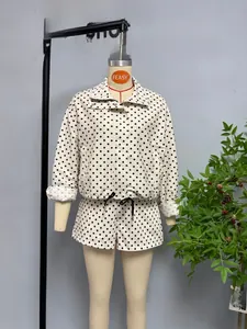 Detailed view of the black polka dot seersucker jacket featuring a drawstring waist design