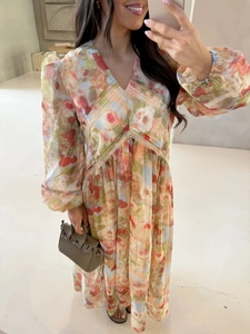 Detailed view of the V-neck lace trim and floral chiffon fabric on the long sleeve dress