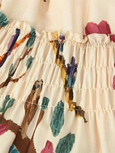 Detail of smocking process and cactus floral print on beige cotton blend fabric