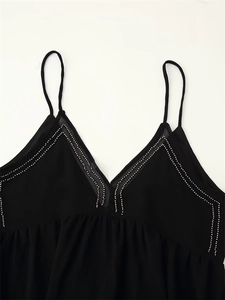 Detail of black V-neck camisole with silver rhinestone trim and thin spaghetti straps