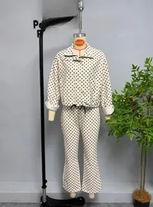 Detail of vintage polka dot bubble crepe jacket and flared pants set on a mannequin