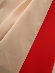 Detailed macro shot showing beige and red textured fabric for shawl collar blazers